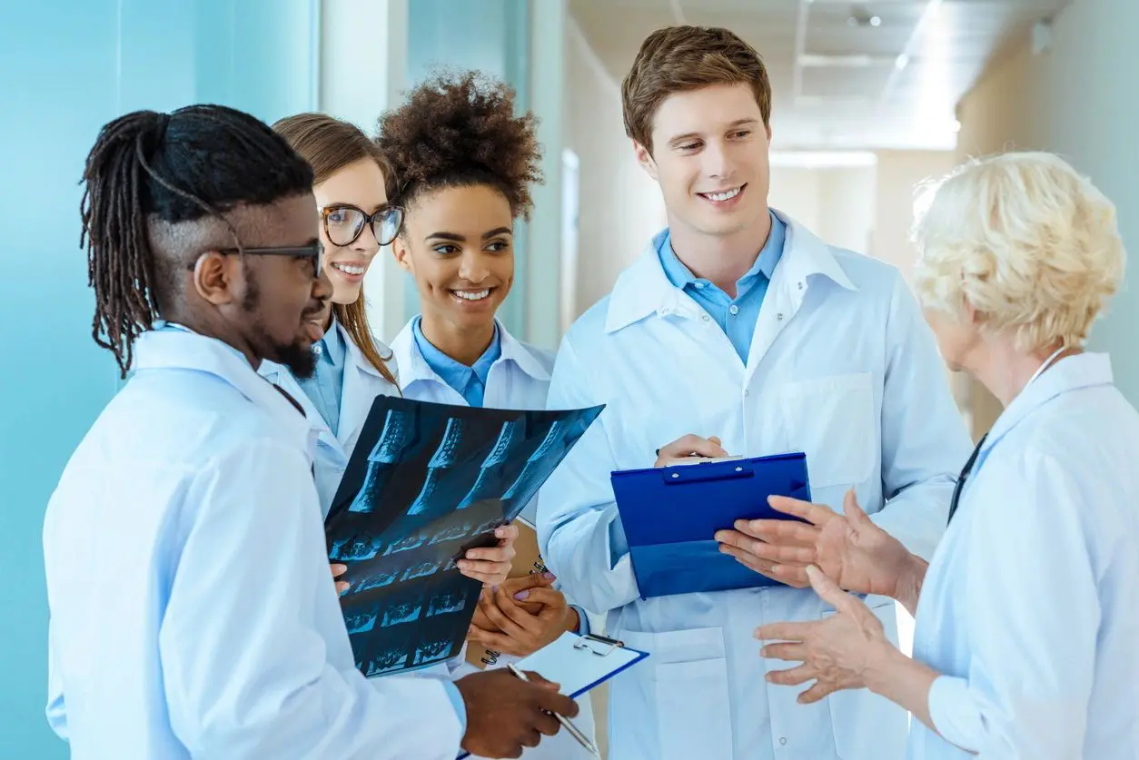 A group of doctors standing around each other.